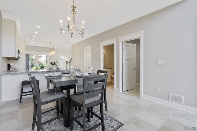 tiled dining space featuring an inviting chandelier