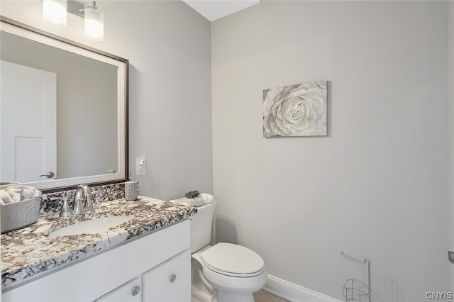 bathroom featuring toilet and large vanity