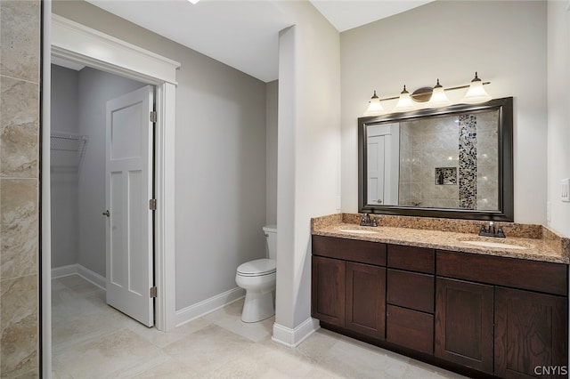 bathroom with double sink vanity, tile floors, and toilet