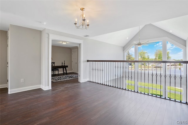 additional living space featuring lofted ceiling, dark wood-type flooring, and ceiling fan with notable chandelier