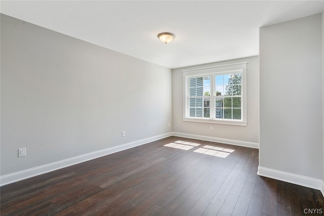 spare room featuring dark hardwood / wood-style floors