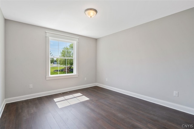 spare room featuring dark hardwood / wood-style flooring