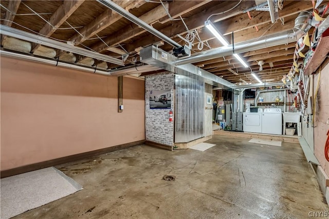 basement featuring sink, water heater, and washer and clothes dryer