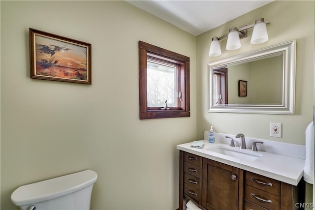 bathroom featuring toilet and vanity