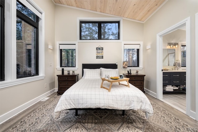 bedroom featuring lofted ceiling, crown molding, ensuite bath, and wooden ceiling