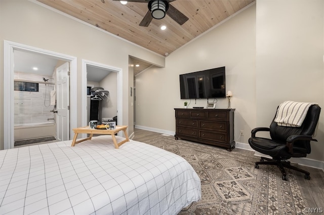 bedroom featuring ceiling fan, light wood-type flooring, connected bathroom, and vaulted ceiling