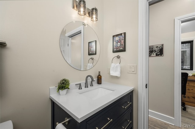 bathroom featuring hardwood / wood-style flooring and vanity