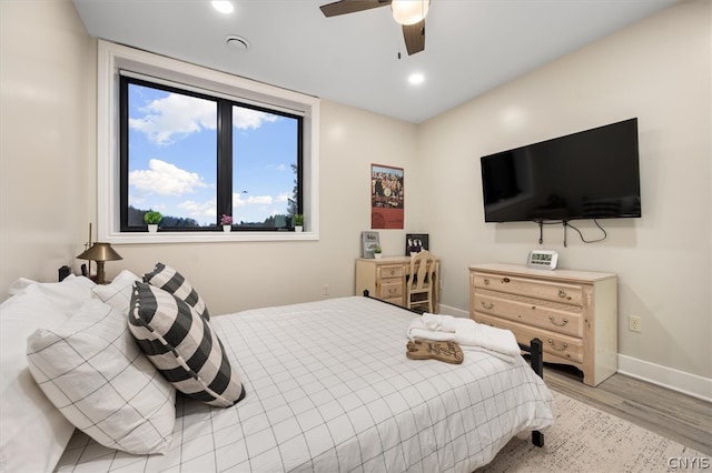 bedroom featuring ceiling fan and light hardwood / wood-style flooring