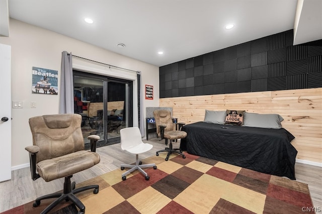 bedroom featuring wood-type flooring and access to exterior