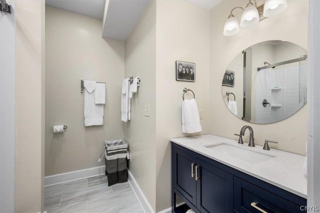 bathroom featuring walk in shower and vanity