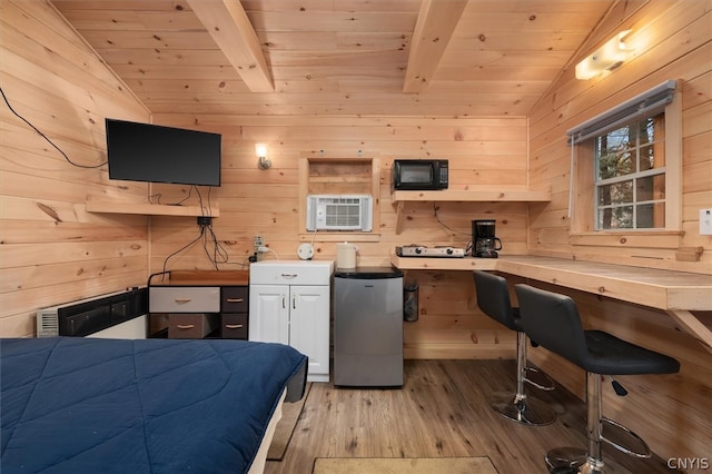 kitchen with wood ceiling, light hardwood / wood-style floors, stainless steel refrigerator, and wooden walls