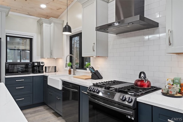 kitchen featuring wall chimney exhaust hood, backsplash, stainless steel appliances, hanging light fixtures, and white cabinetry