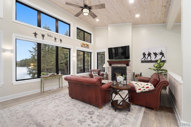 living room with high vaulted ceiling, ceiling fan, wooden ceiling, and light hardwood / wood-style floors