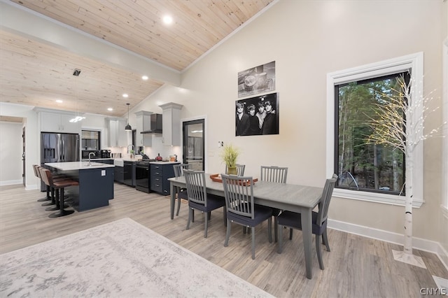 dining room with light wood-type flooring, high vaulted ceiling, and wooden ceiling