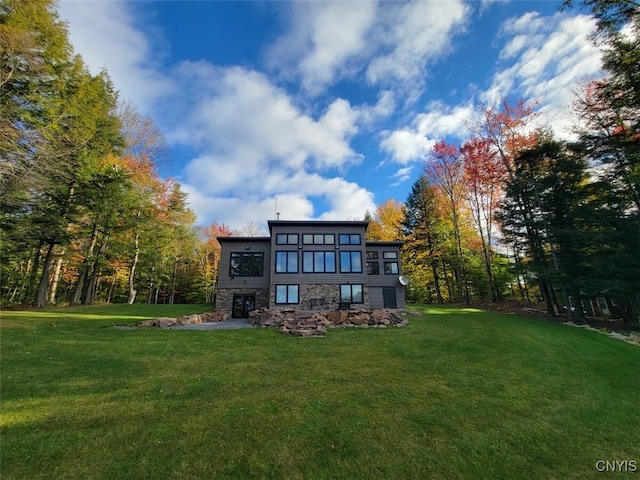 rear view of house featuring a lawn