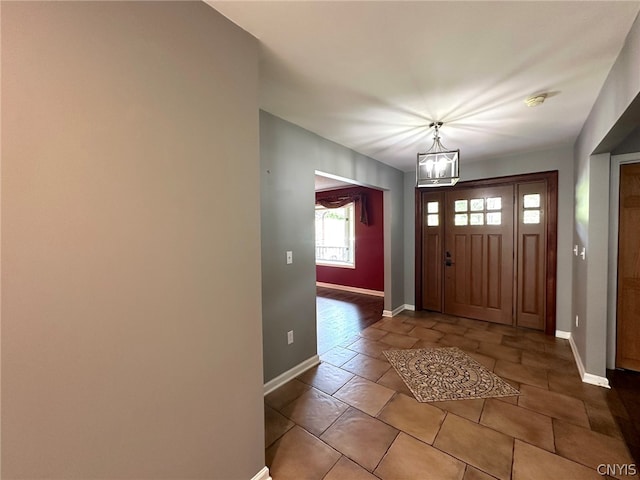 entrance foyer featuring a notable chandelier and tile patterned floors