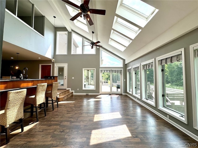 interior space featuring vaulted ceiling with skylight and ceiling fan