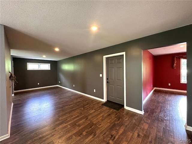 empty room featuring a textured ceiling and hardwood / wood-style flooring