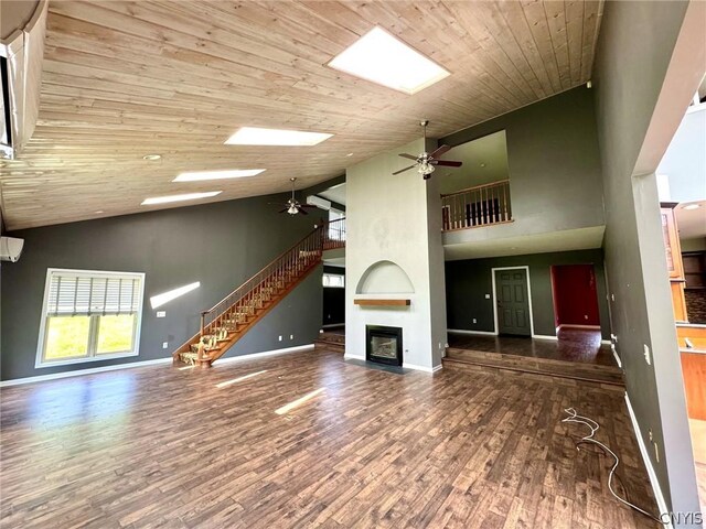 unfurnished living room with a fireplace, ceiling fan, hardwood / wood-style floors, high vaulted ceiling, and wood ceiling