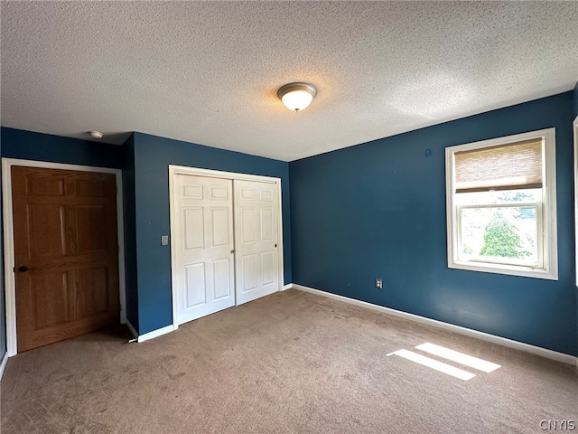 unfurnished bedroom featuring carpet and a textured ceiling