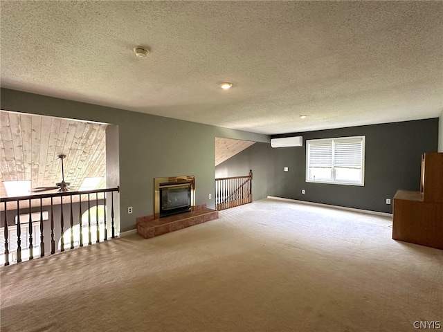 interior space with a textured ceiling, fridge, carpet floors, ceiling fan, and a wall mounted air conditioner