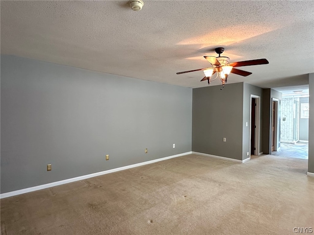 unfurnished room featuring a textured ceiling, light colored carpet, and ceiling fan