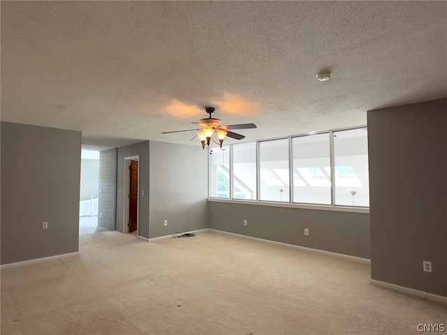 empty room with carpet, a textured ceiling, and ceiling fan