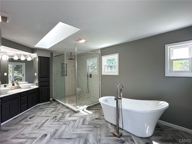 bathroom with plenty of natural light, parquet floors, and separate shower and tub