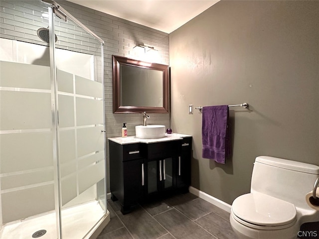 bathroom featuring vanity, toilet, an enclosed shower, and tile patterned flooring