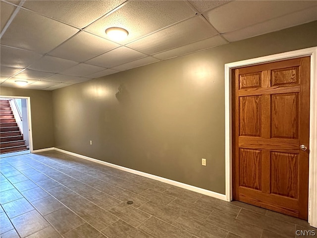 empty room featuring a paneled ceiling