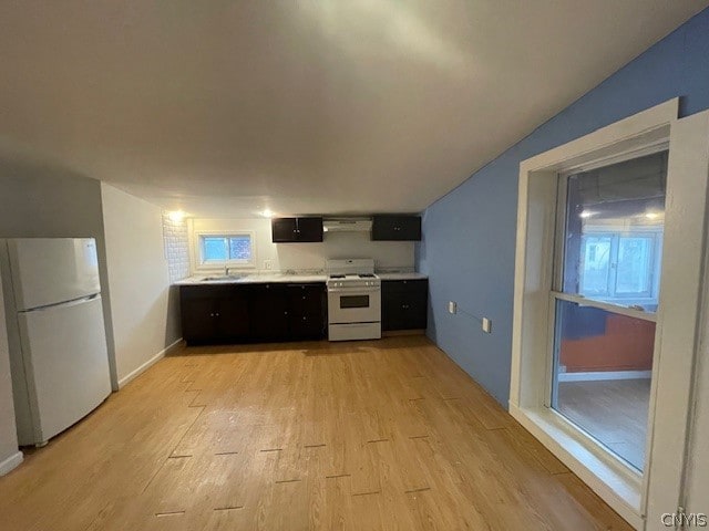 kitchen featuring white appliances, sink, exhaust hood, and light hardwood / wood-style flooring