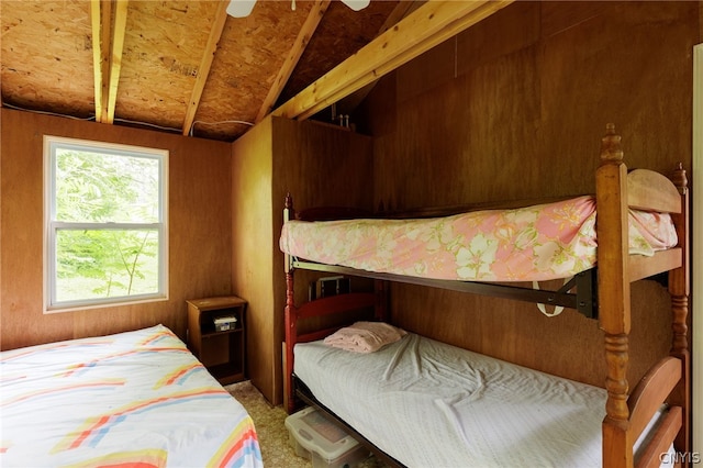 bedroom with lofted ceiling, ceiling fan, and carpet