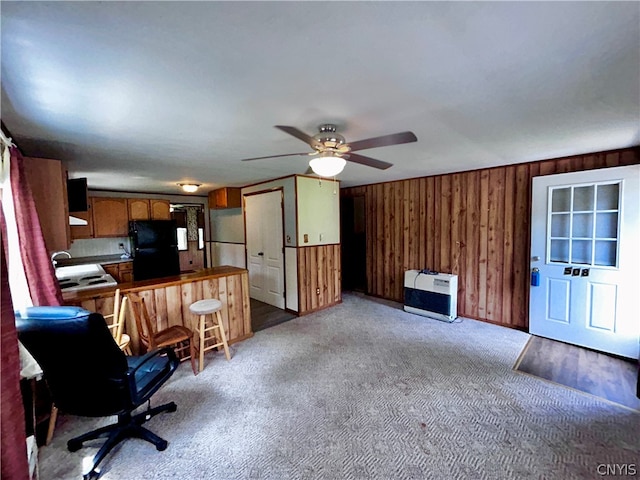 carpeted office space with sink and ceiling fan