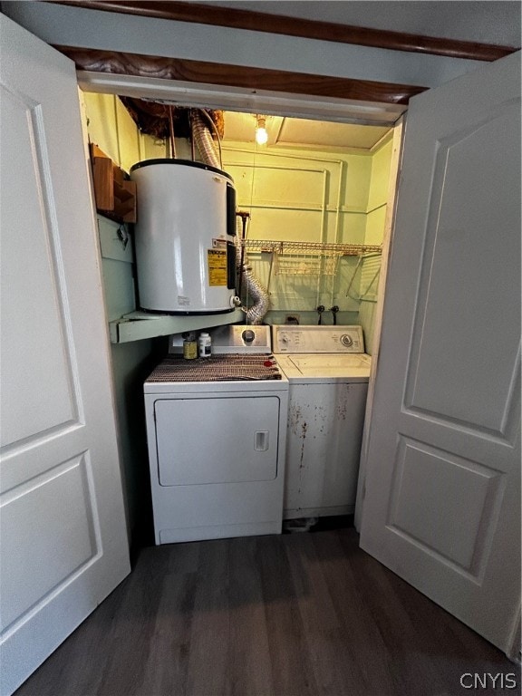 clothes washing area featuring separate washer and dryer, water heater, and dark hardwood / wood-style floors