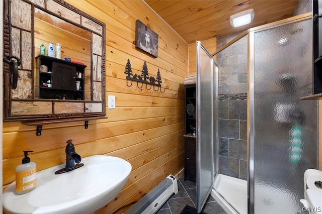 bathroom featuring an enclosed shower, wooden walls, and tile flooring