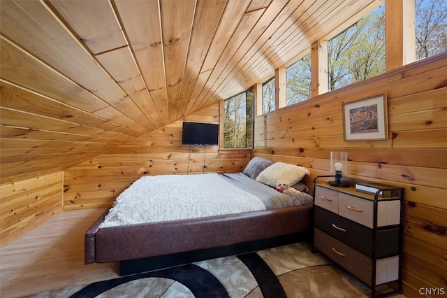 bedroom featuring wood walls, vaulted ceiling, hardwood / wood-style floors, and wooden ceiling