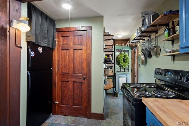 kitchen featuring black appliances and dark tile floors