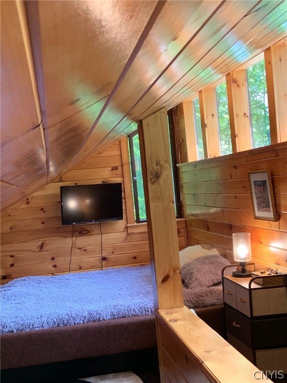 bedroom featuring wood walls, wooden ceiling, and vaulted ceiling