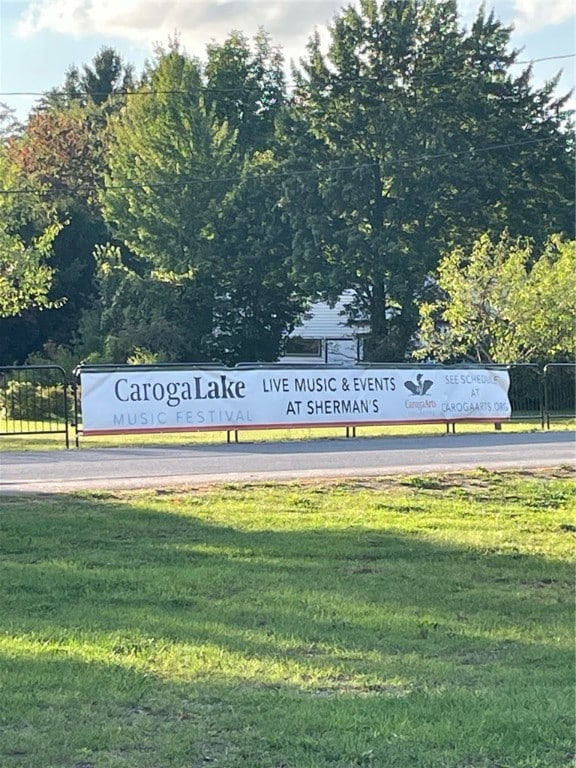 community / neighborhood sign with a yard