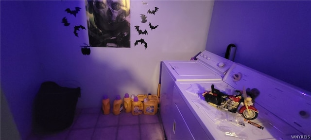 laundry area with washing machine and clothes dryer and tile flooring