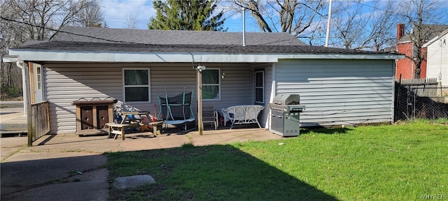 rear view of house with a patio area and a lawn