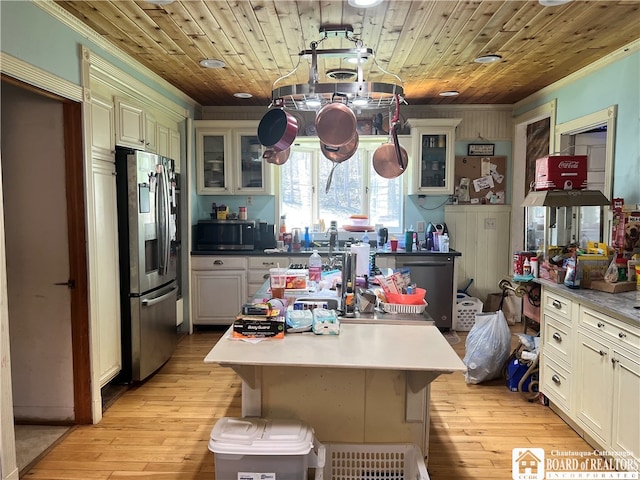 kitchen featuring light wood-type flooring, stainless steel appliances, and wood ceiling