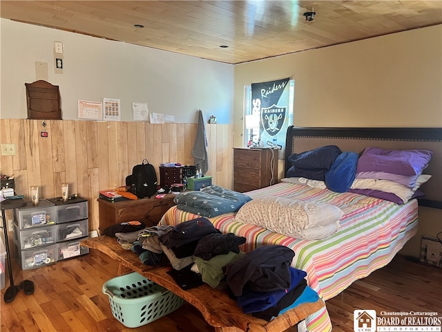 bedroom featuring wooden ceiling and dark wood finished floors