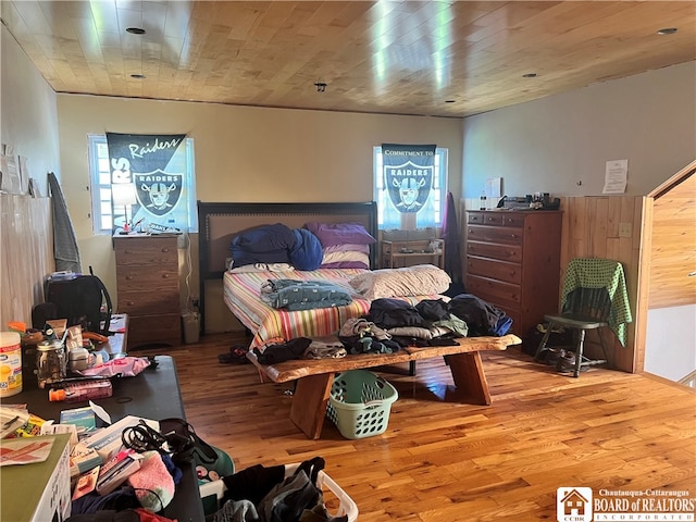 bedroom with wooden ceiling and light wood-style flooring