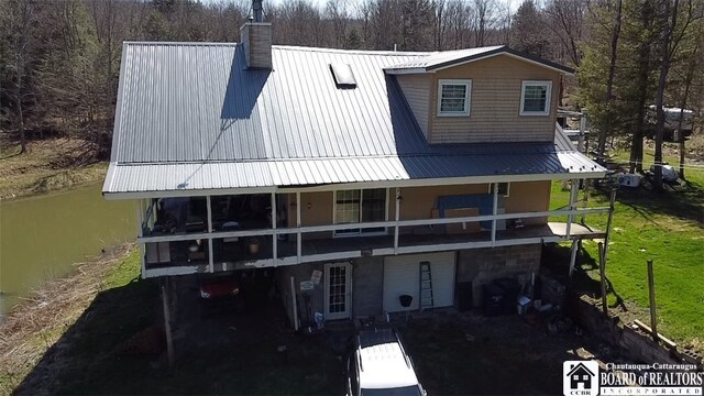 back of house with a water view