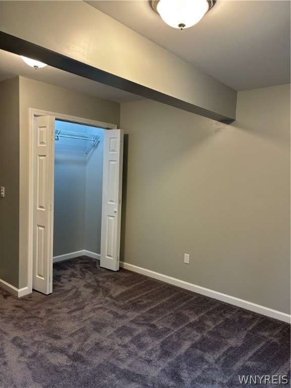 interior space featuring dark colored carpet