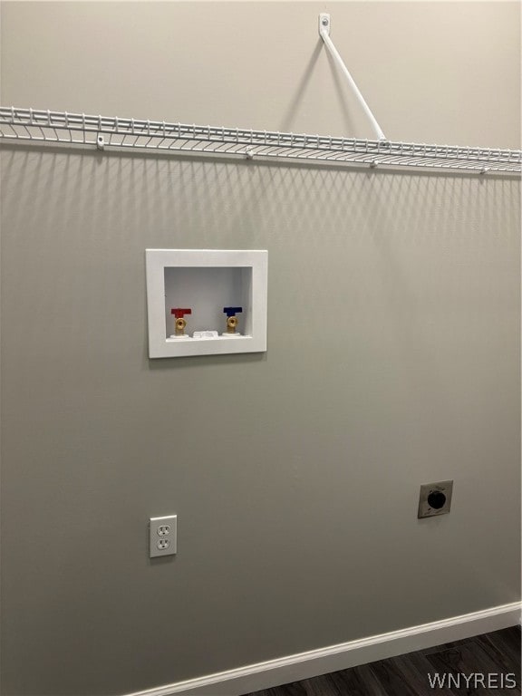 clothes washing area featuring dark hardwood / wood-style flooring, hookup for a washing machine, and electric dryer hookup