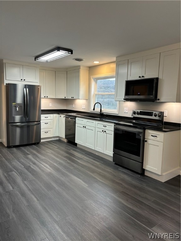 kitchen featuring sink, white cabinetry, black appliances, and dark hardwood / wood-style floors