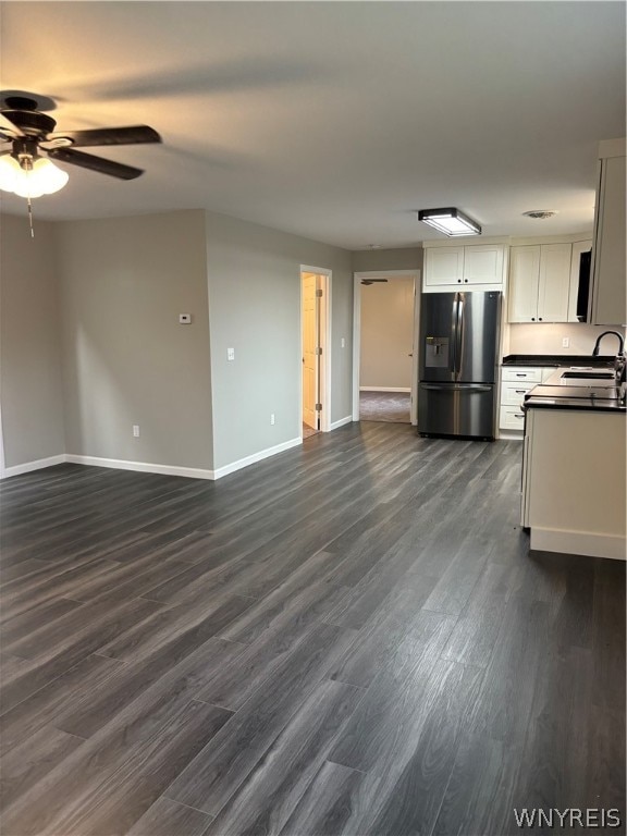 kitchen featuring dark wood-type flooring, ceiling fan, white cabinets, and stainless steel refrigerator with ice dispenser