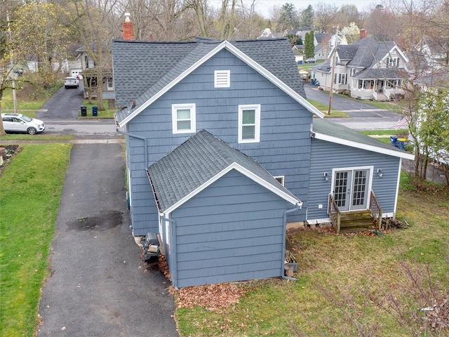 back of property with a lawn